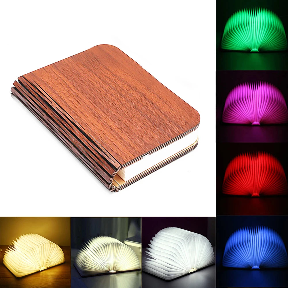 Folding book lamp open in a full circle, glowing warm on a shelf